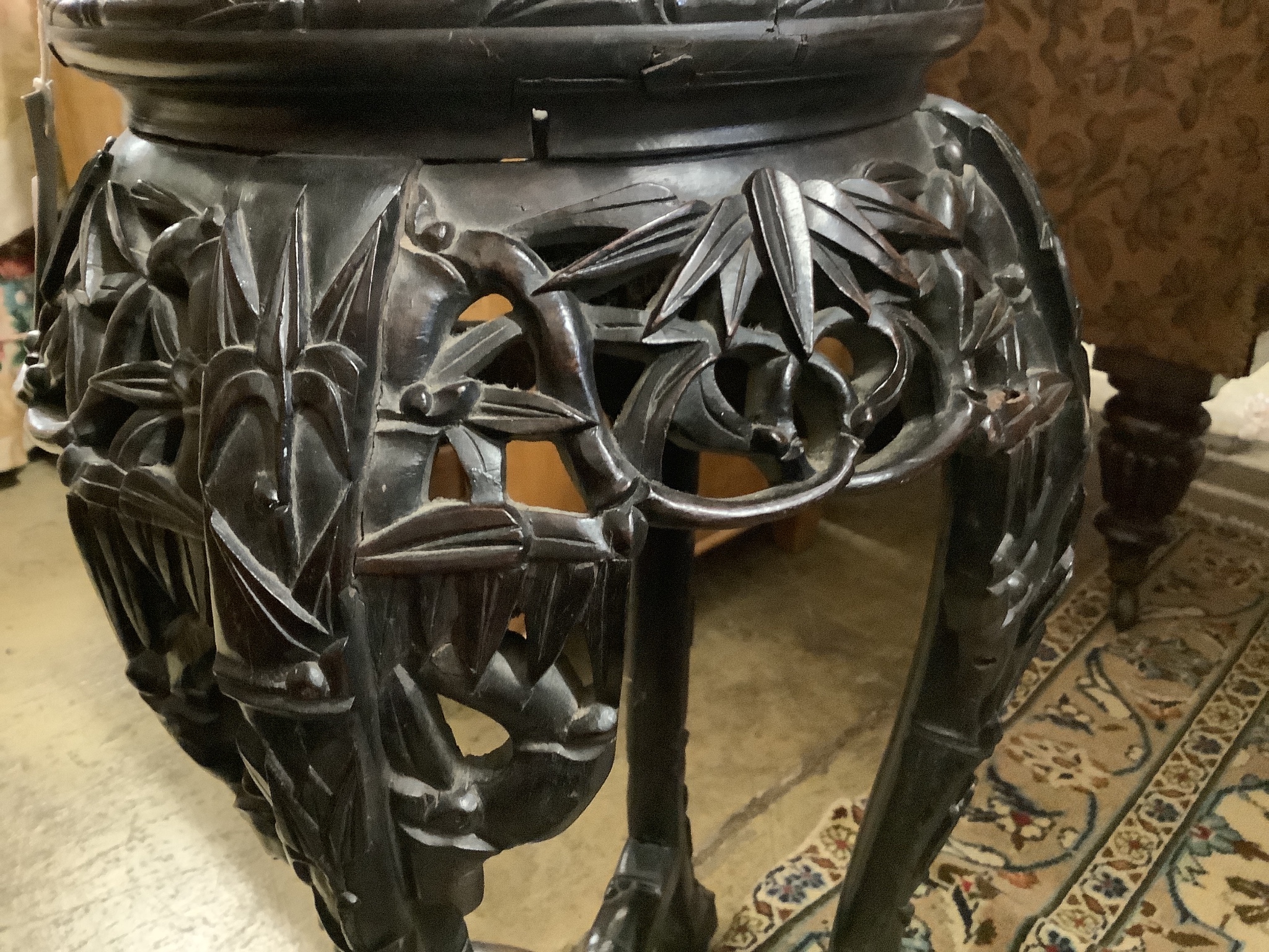 A Chinese carved hardwood marble top vase stand